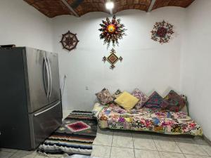 a living room with a couch and a refrigerator at Casa Katrina #2 in Sayulita