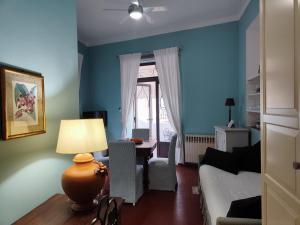 ein Wohnzimmer mit blauen Wänden und einem Tisch mit einer Lampe in der Unterkunft Jasmine in Letojanni