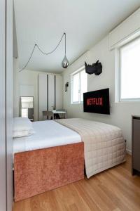 a bedroom with a bed with a netflix sign on it at art of design & terrace in Milan