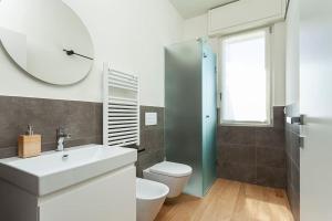 a bathroom with a sink and a toilet and a mirror at art of design & terrace in Milan