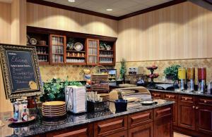 a kitchen with a counter with plates and dishes at Homewood Suites by Hilton East Rutherford - Meadowlands, NJ in East Rutherford