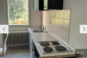 a kitchen with a stove top oven next to a sink at Tacidur Home in Tuttlingen