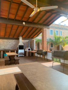 a large patio with a table and a fireplace at Hotel Il Castello in Villa Concepción