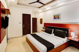 a bedroom with a large bed in a room at Hotel Raaz Luxury Near Delhi Airport in New Delhi