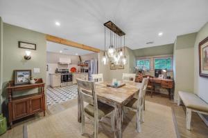 a dining room and kitchen with a table and chairs at Luxury Loft in Historic Carriage House in Kennett Square
