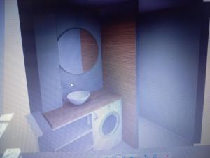 a bathroom with a toilet and a sink and a mirror at ANDISE in Courseulles-sur-Mer