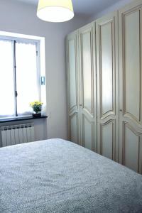 a bedroom with a bed and a large closet at Casetta di Quarto in Genoa