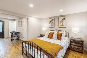 a bedroom with a bed with a yellow blanket at Houston Hideaway - Unit C in Houston