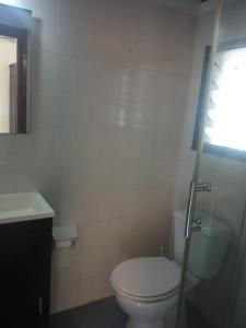 uma casa de banho branca com um WC e um lavatório em La casina del Güeña em Cangas de Onís