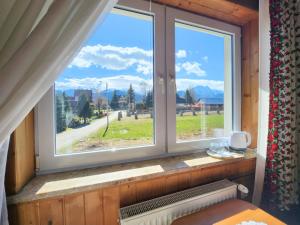 a window with a view of a field at Willa u Renaty - Widok na Giewont in Zakopane