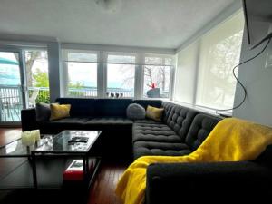 a living room with a couch and a table at Cozy Waterfront Cottage in Victoria Harbour in Victoria Harbour