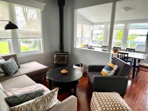 a living room with a couch and a stove at Cozy Waterfront Cottage in Victoria Harbour in Victoria Harbour