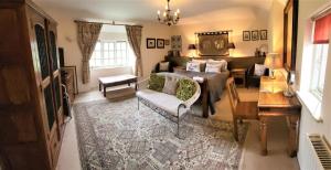 een woonkamer met een bed en een tafel bij escape the ordinary - Piddle Inn the Home private self cater holiday in Dorchester
