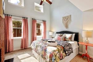 a bedroom with a bed and two windows at Cooper House Fells Point Large Fenced In Yard in Baltimore