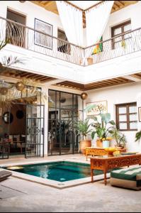 a house with a swimming pool and a balcony at Riad Deha & Spa in Marrakech