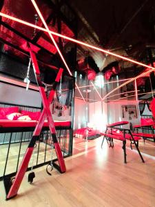 a room with red bunk beds and a pair of scissors at BDSM apartmán v Bratislave -ADULTS ONLY in Bratislava