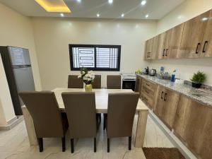 a kitchen with a dining room table and chairs at Complexe La Perfection in Nouakchott