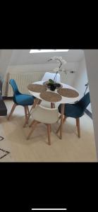 a table and chairs with a vase on top of it at Le petit Treguier in Tréguier