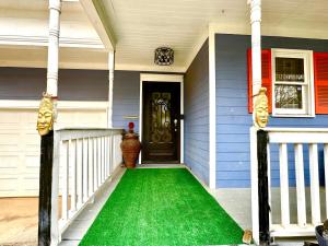 a front door of a house with a green lawn at African Zen Oasis in Atlanta