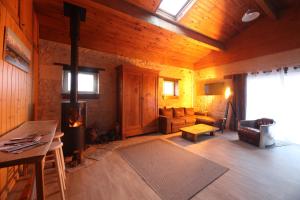 a living room with a fireplace in a wooden house at The Wild Seeds in Chauvigny