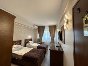 a hotel room with two beds and a window at Hotel Ana in Constanţa