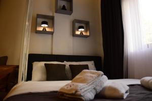 a bedroom with a bed with a mirror and two lights at Apartman Suny N58- SPA -Gratis in Kopaonik