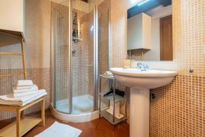 a bathroom with a sink and a shower at La Dimora nell'Anfiteatro Superior room and apartment Self check in Elevator Air Conditioning in Lucca +79 photos