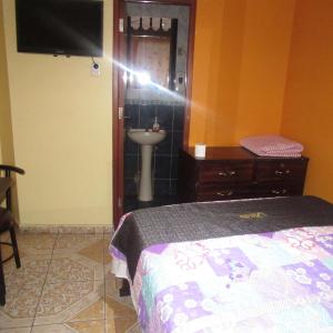 Ένα ή περισσότερα κρεβάτια σε δωμάτιο στο Gran Hostal Los Pinos