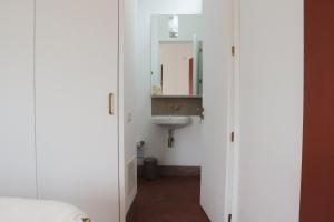 a bathroom with a sink and a mirror at Monte das Açoteias - Agroturismo in Tavira