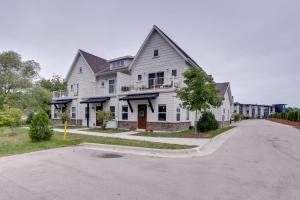 a large white house on a street at Riverfront Sheboygan Townhome with Grill! in Sheboygan