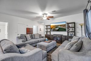 a living room with couches and a flat screen tv at Scottsdale Casa del Sol- North Scottsdale with Private Pool, Hot Tub, Putting Green and More! in Phoenix