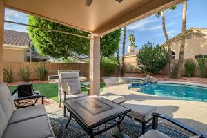 a patio with chairs and a table and a pool at Scottsdale Casa del Sol- North Scottsdale with Private Pool, Hot Tub, Putting Green and More! in Phoenix