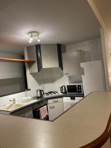 a kitchen with a stove and a refrigerator at Welcome in Chambéry