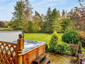 a hot tub on the deck of a garden at 3 Bed in Peebles LK15M in Walston