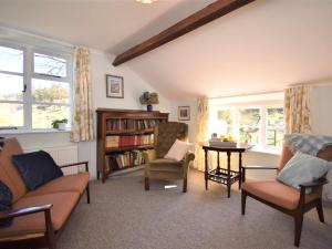 a living room with a couch and chairs and a table at 4 Bed in Eskdale SZ158 in Eskdale