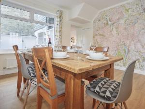 a dining room with a wooden table and chairs at 4 Bed in Keswick SZ443 in Keswick