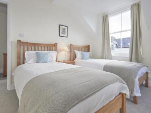 two beds in a bedroom with a window at 4 Bed in Keswick SZ443 in Keswick