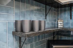 a row of cups sitting on a shelf in a kitchen at NEW ENTIRE PLACE Cozy QUIET 2B2B TOWNHOUSE SP1267 in Norcross +25 photos