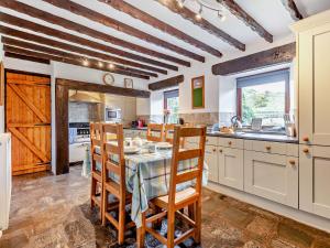 a kitchen with a table and chairs in a room at 3 Bed in Bampton 92037 in Bampton