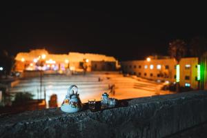 a group of figurines sitting on a ledge at night at Beit alkaram in Kerak