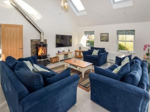 a living room with blue couches and a fireplace at 3 Bed in Blackpool 83787 in Hambleton