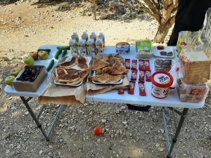 a picnic table with food and drinks on it at Beit alkaram in Kerak