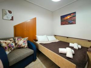 a small bedroom with a bed and a chair at Simos Summer House in Fanari in Fanárion