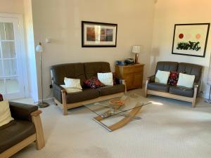 a living room with two couches and a coffee table at Cottage in Ayr