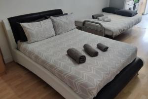a large bed with two pillows on top of it at Large Studio Garden Flat on Golders Green Road in London
