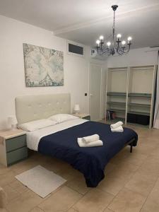 a bedroom with a bed with two towels on it at Villa Chiara in Santo Stefano al Mare