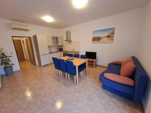 a living room with a blue couch and a table at Apartment Greta in Kanfanar +27 photos