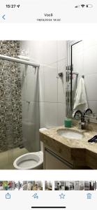 a bathroom with a shower and a toilet and a sink at Casa Rio verde in Rio Verde