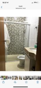 a bathroom with a shower with a toilet and a sink at Casa Rio verde in Rio Verde