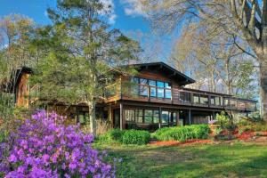 a wooden house with flowers in front of it at 4 Seasons Lodge in Gatlinburg